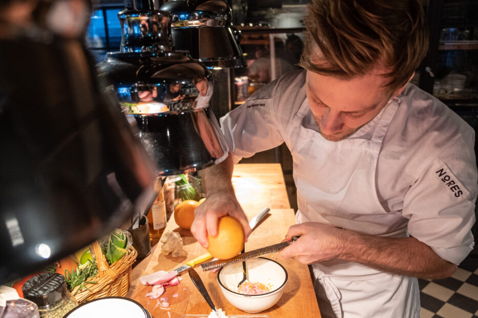 a chef making food - sqeezing a lemon